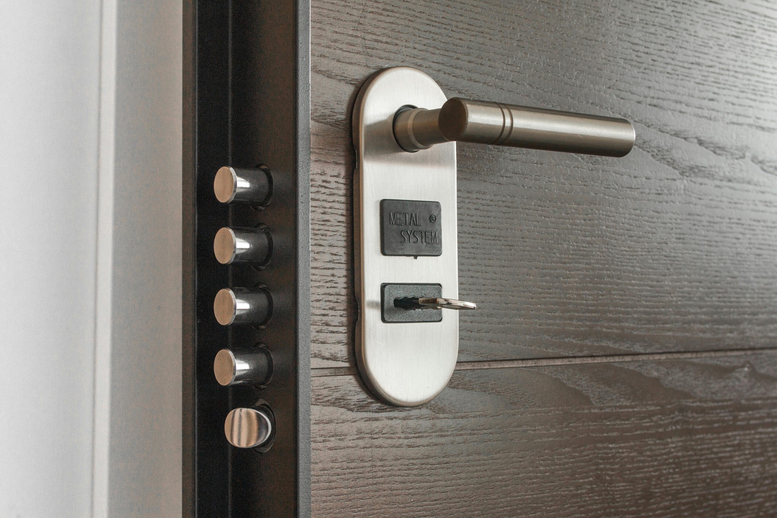 pexels photo 279810 279810 Metal door handle and lock system with key inserted, showcasing security features.